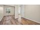 Bright bedroom featuring wood-look floors and mirrored closet doors at 5762 Benevento Dr, Sarasota, FL 34238