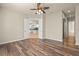 Bright bedroom with wood floors and views into kitchen and bathroom at 5762 Benevento Dr, Sarasota, FL 34238