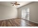 Spacious bedroom with wood flooring and sliding doors leading to exterior at 5762 Benevento Dr, Sarasota, FL 34238