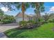 Tan house with white garage door and palm trees in the front yard at 5762 Benevento Dr, Sarasota, FL 34238