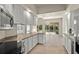 Modern kitchen with white cabinets and stainless steel appliances. Views of the backyard at 5762 Benevento Dr, Sarasota, FL 34238