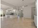 Open floor plan with tile floors, kitchen island, and a ceiling fan at 5762 Benevento Dr, Sarasota, FL 34238