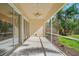 Relaxing screened porch with ceiling fans, extending the living space outdoors at 5762 Benevento Dr, Sarasota, FL 34238