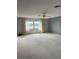 Large living room with light walls and carpeted floors at 702 67Th W St, Bradenton, FL 34209