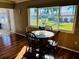 Dining area with wood table and four chairs, overlooking garden at 7315 8Th W Ave, Bradenton, FL 34209