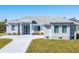 Newly constructed home with gray exterior, driveway, and landscaping at 10489 St Paul Dr, Port Charlotte, FL 33981