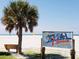 Siesta Beach entrance with palm trees and bench at 1667 Laurel St, Sarasota, FL 34236