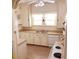 Galley kitchen with white cabinets and tiled floor at 1667 Laurel St, Sarasota, FL 34236