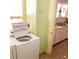 Laundry room with washer, dryer, and storage cabinet at 1667 Laurel St, Sarasota, FL 34236