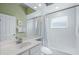 Clean bathroom with a shower/tub combo, vanity, and white tile at 5200 Highbury Cir, Sarasota, FL 34238