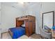 Bedroom with built-in bunk beds, desk and chairs at 5200 Highbury Cir, Sarasota, FL 34238