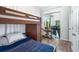 Bedroom with bunk beds, private access to backyard at 5200 Highbury Cir, Sarasota, FL 34238