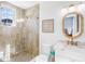 Bathroom with beige tile shower, gold fixtures and a window at 551 S Washington Dr, Sarasota, FL 34236