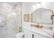 Modern bathroom with marble shower, gold fixtures, and white vanity at 551 S Washington Dr, Sarasota, FL 34236