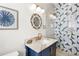 Stylish bathroom with a blue vanity and patterned shower at 551 S Washington Dr, Sarasota, FL 34236