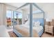 Light and airy bedroom with a canopy bed and balcony access at 551 S Washington Dr, Sarasota, FL 34236