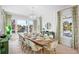 Elegant dining room with water views and a large wooden table at 551 S Washington Dr, Sarasota, FL 34236