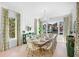 Bright dining room with large windows, wooden table, and green accents at 551 S Washington Dr, Sarasota, FL 34236