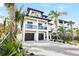 Two-story home with two-car garage and tropical landscaping at 551 S Washington Dr, Sarasota, FL 34236