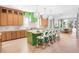 Modern kitchen with green island, white cabinetry and marble counters at 551 S Washington Dr, Sarasota, FL 34236