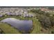 Aerial view of community homes and lake at 5554 Sand Fossil Ct, Sarasota, FL 34238