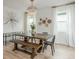 Farmhouse style dining room featuring a long wooden table and bench at 5554 Sand Fossil Ct, Sarasota, FL 34238