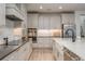 Sleek kitchen with white shaker cabinets, quartz countertops, and farmhouse sink at 5554 Sand Fossil Ct, Sarasota, FL 34238