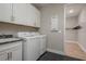 Laundry room with washer, dryer, cabinets and closet at 5554 Sand Fossil Ct, Sarasota, FL 34238