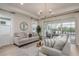 Bright living room with sliding glass doors leading to a pool and patio at 5554 Sand Fossil Ct, Sarasota, FL 34238