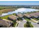 Aerial view of community with lake and homes at 5987 Snowy Egret Dr, Sarasota, FL 34238