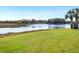 Serene backyard with lake view and grassy area at 5987 Snowy Egret Dr, Sarasota, FL 34238