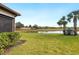 Spacious backyard with pond view and lush landscaping at 5987 Snowy Egret Dr, Sarasota, FL 34238