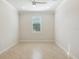 Well-lit bedroom featuring light tile floors and a ceiling fan at 5987 Snowy Egret Dr, Sarasota, FL 34238