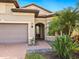 Front entry of home with walkway and landscaping at 5987 Snowy Egret Dr, Sarasota, FL 34238