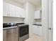 Laundry room with white cabinets, washer and dryer, and a black countertop at 5987 Snowy Egret Dr, Sarasota, FL 34238