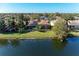 Aerial view of single-Gathering home with pool and solar panels, situated on a canal at 13951 Wood Duck Cir, Lakewood Ranch, FL 34202