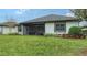 House with backyard, grass, and screened porch at 6839 Chester Trl, Bradenton, FL 34202