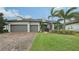 Two-story house with gray siding, two-car garage, and landscaping at 6839 Chester Trl, Bradenton, FL 34202