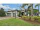 Two-story house with gray siding, two-car garage, and landscaping at 6839 Chester Trl, Bradenton, FL 34202