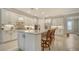 Stylish kitchen boasting white cabinets and a large island at 6839 Chester Trl, Bradenton, FL 34202
