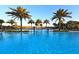 Resort-style pool with palm trees and lounge chairs at 6839 Chester Trl, Bradenton, FL 34202