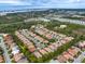 Aerial view of a community with many houses and lush landscaping at 9143 Willow Brook Dr, Sarasota, FL 34238