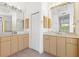 Double vanity bathroom with light wood cabinets at 9143 Willow Brook Dr, Sarasota, FL 34238