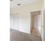 Bedroom with double door closet and access to hallway at 9143 Willow Brook Dr, Sarasota, FL 34238