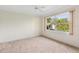 Spacious bedroom with large window and wall-to-wall carpet at 9143 Willow Brook Dr, Sarasota, FL 34238