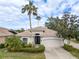 Tan one-story house with tile roof and two-car garage at 9143 Willow Brook Dr, Sarasota, FL 34238