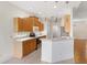 Kitchen with light wood cabinets and an island at 9143 Willow Brook Dr, Sarasota, FL 34238