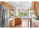 Kitchen with light wood cabinets, stainless steel appliances, and a breakfast bar at 9143 Willow Brook Dr, Sarasota, FL 34238