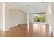 Large living room with hardwood floors and sliding glass doors at 9143 Willow Brook Dr, Sarasota, FL 34238