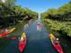 A beautiful waterway provides the perfect backdrop for kayaks, under a blue sky surrounded by lush trees at 1305 4Th St # 402P, Sarasota, FL 34236